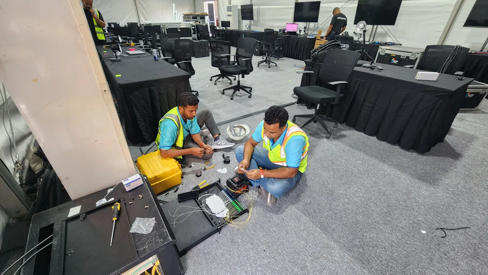 IP Care technicians terminating and splicing fiber optic cable in the media area at Etihad Arena