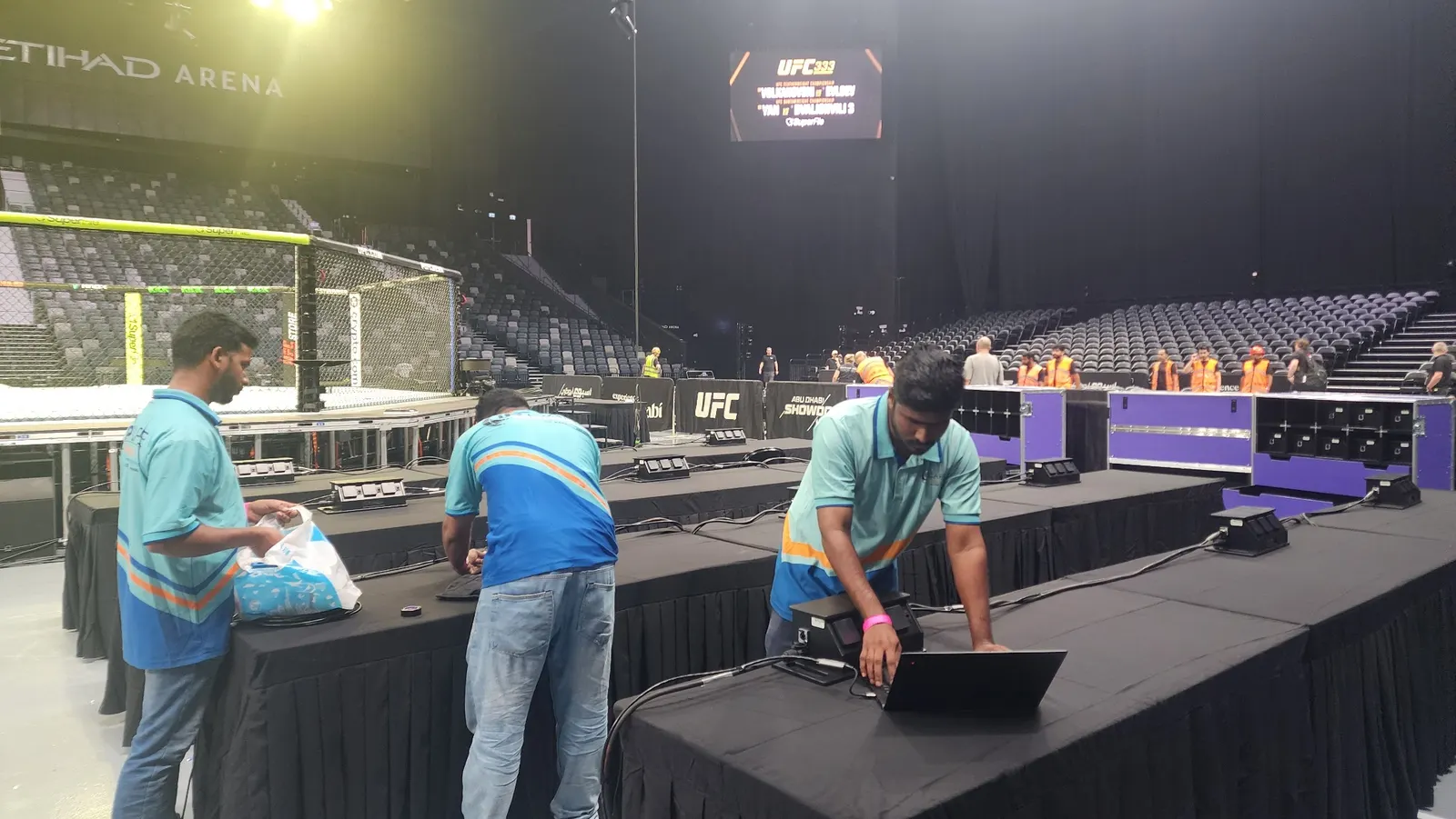 IP Care engineers testing desk connectivity in the media seating area at Etihad Arena