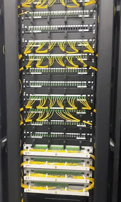 Rack of terminated fiber patch panels with single-mode patch cords installed by IP Care at Al Jeel Tower