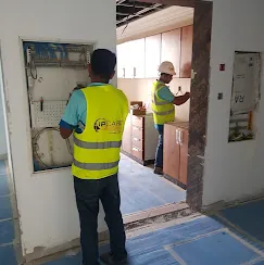 IP Care team commissioning a wall-mounted ELV panel at Al Jeel Tower