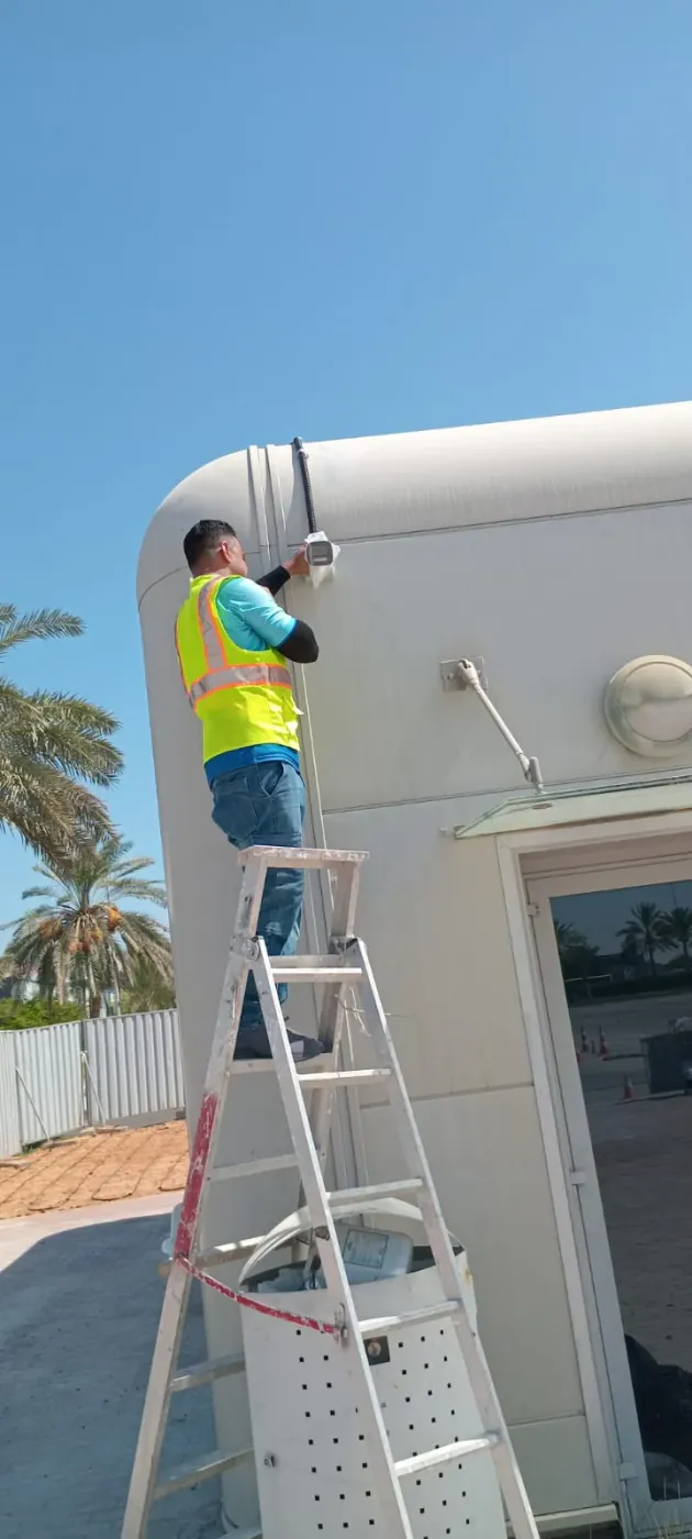 IP Care technician installing an external CCTV camera at Yas Driving Academy