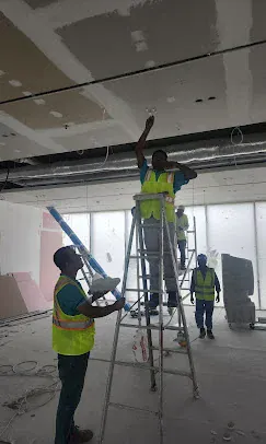 IP Care team installing overhead cabling and containment at Yas Driving Academy